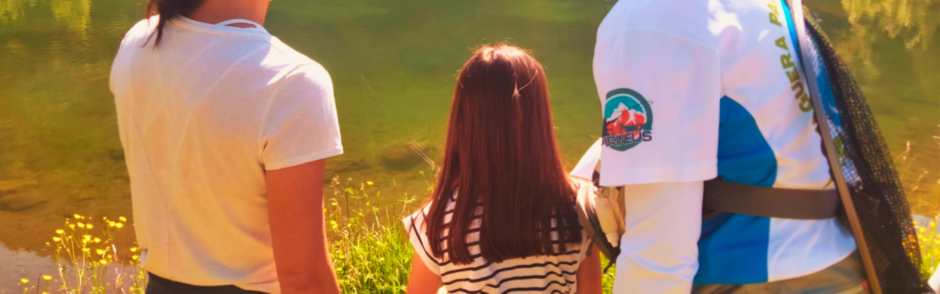 Group of people in a natural setting listening to a guide giving instructions.